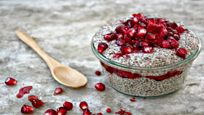 Pudin de chia y vainilla decorado con frutos rojos en vaso de cristal