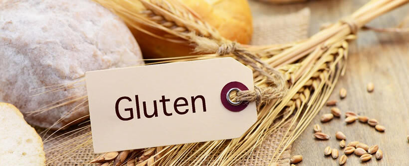 Foto alimentos con gluten y cartel en el que pone gluten